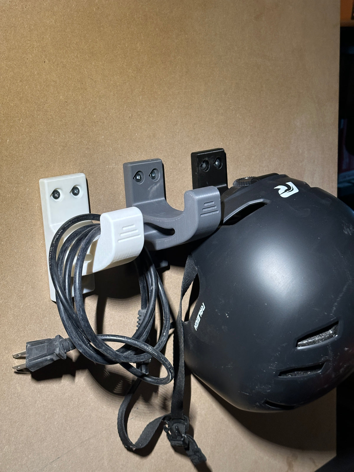 Hooks holding extension cord and bicycle helmet