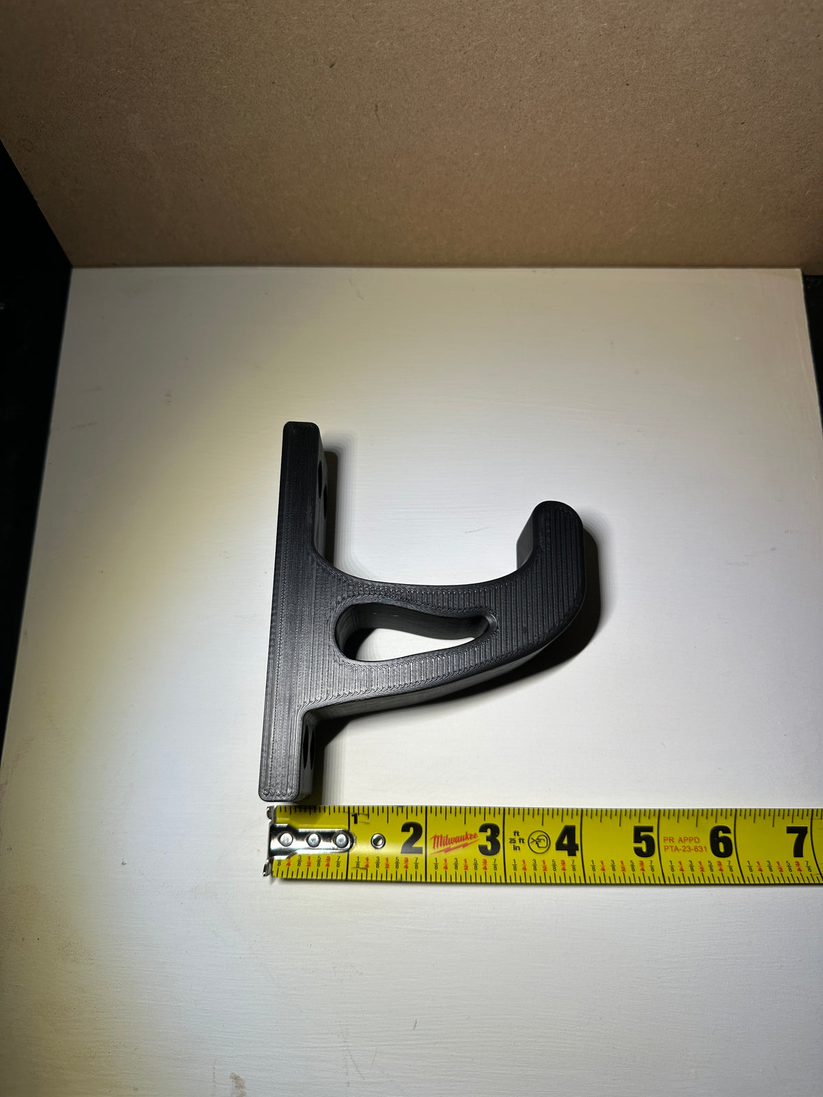 White garage hook holding an extension cord