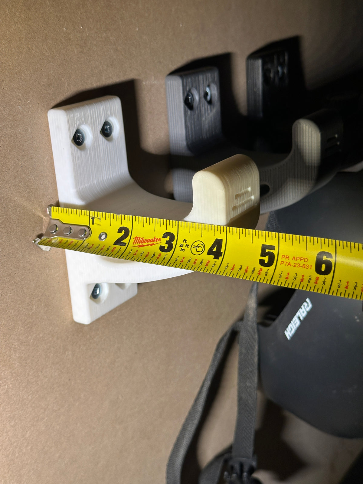 Garage storage hooks mounted on pegboard wall
